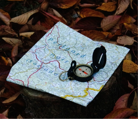 Compass placed on a map for navigation